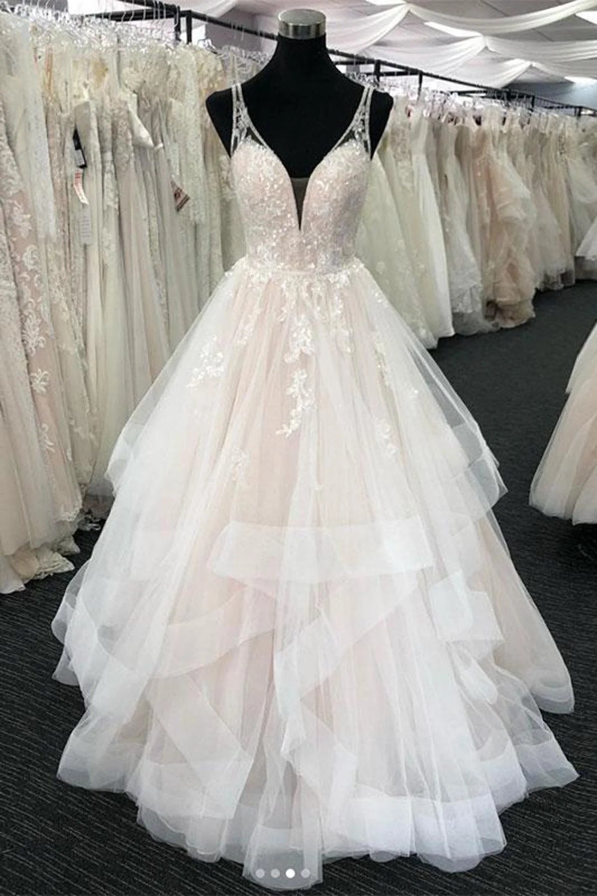 Elegant A-line tulle wedding dress with V-neck and open back.