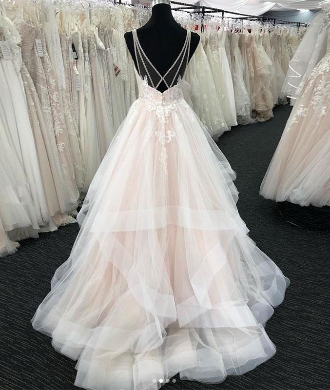 Front view of a layered long A-line wedding dress.