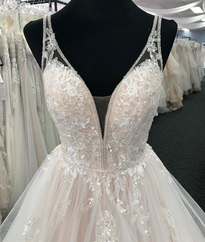 Side profile of a romantic layered tulle wedding gown.