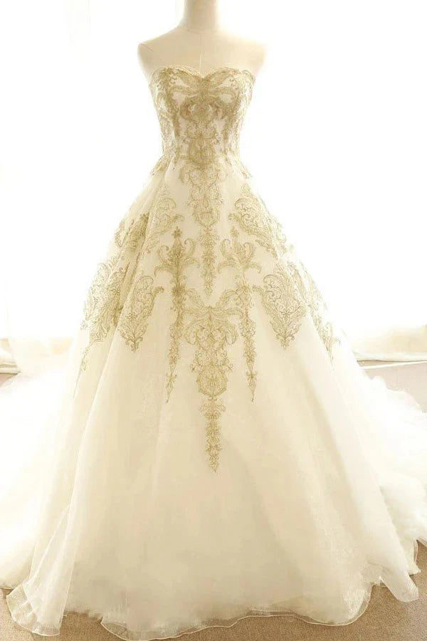 Elegant A-line V-neck wedding dress with appliques and sweep train.