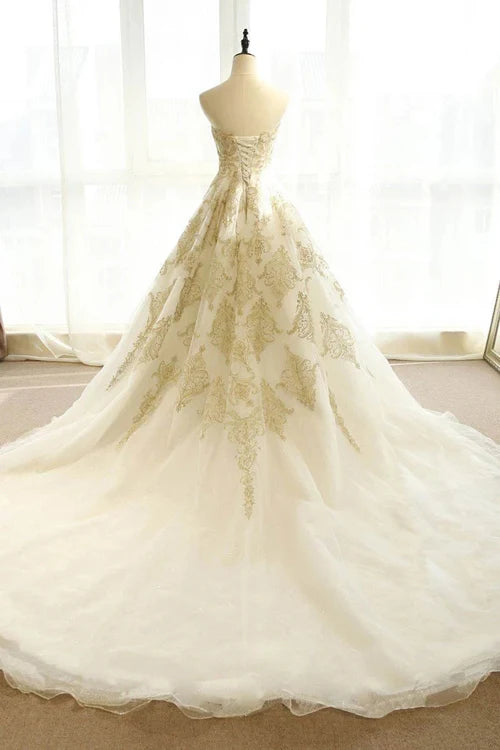 Back view of A-line bridal gown showing sweep train and delicate appliques.