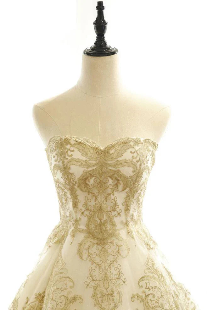 Close-up of V-neckline and applique details on a wedding dress.