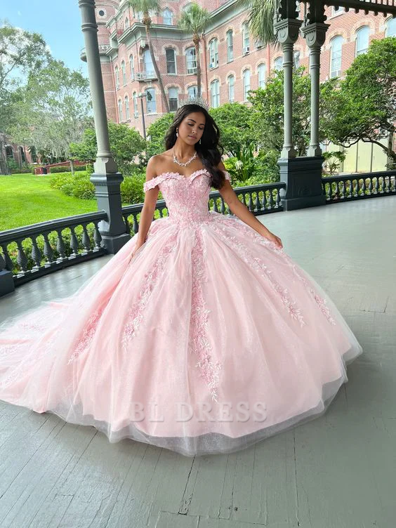 Pink A-line tulle quinceanera dress with floral applique and V-neckline.