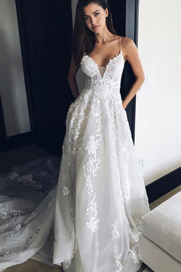 Elegant A-line V-neck wedding dress with spaghetti straps and delicate appliques.