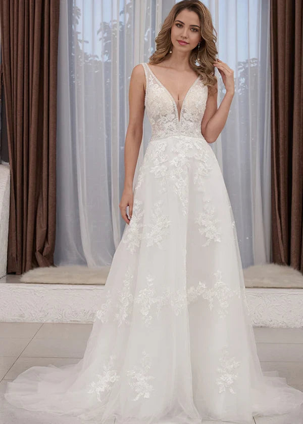 Elegant A-line V-neck wedding dress with lace appliques, perfect for a beach ceremony.