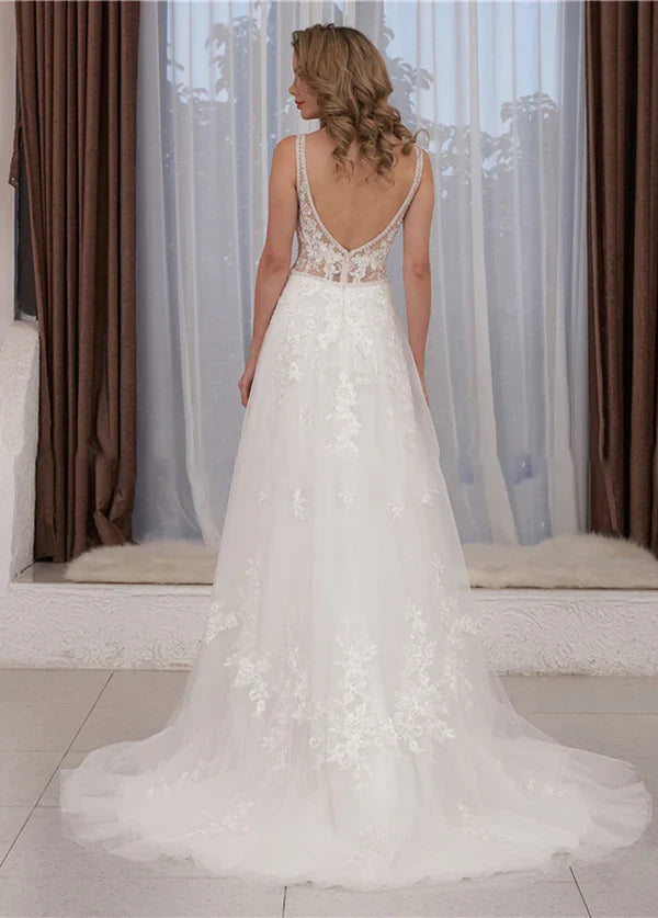 Close-up of the delicate lace appliques on a sleeveless A-line wedding gown.