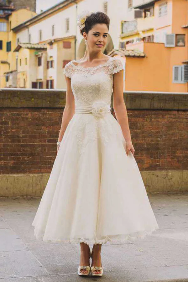 Elegant A-line V-neck tea-length wedding dress with appliqued flowers.