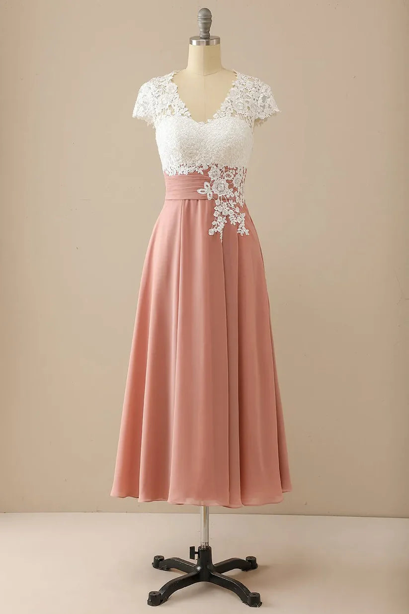 Woman wearing an A-line V-neck mother of the bride dress with appliques and short sleeves.
