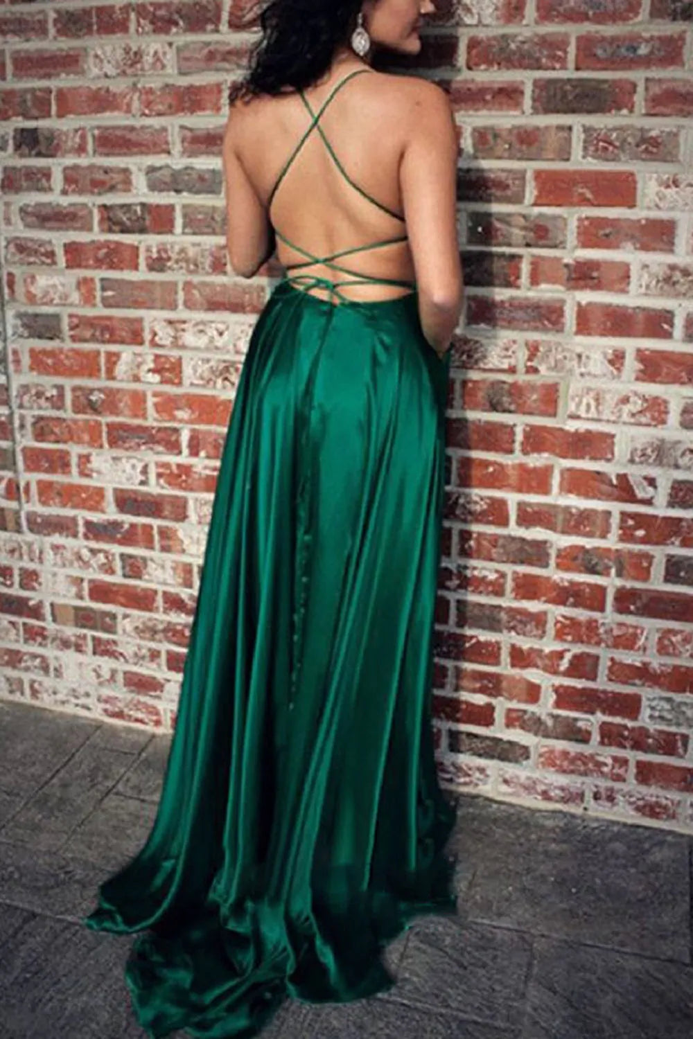 Side view of a flowing A-line satin gown.