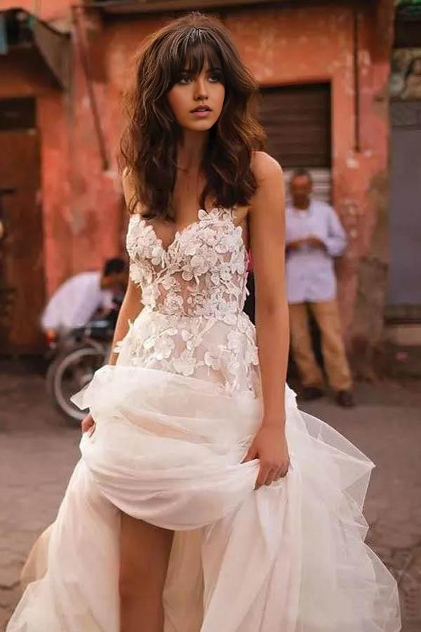 Elegant A-line V-neck backless tulle wedding dress with delicate straps and brush train.
