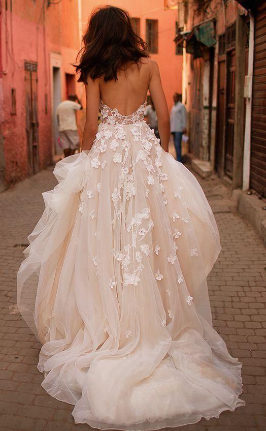 Back view of an A-line V-neck wedding dress, showcasing the backless design and brush train.