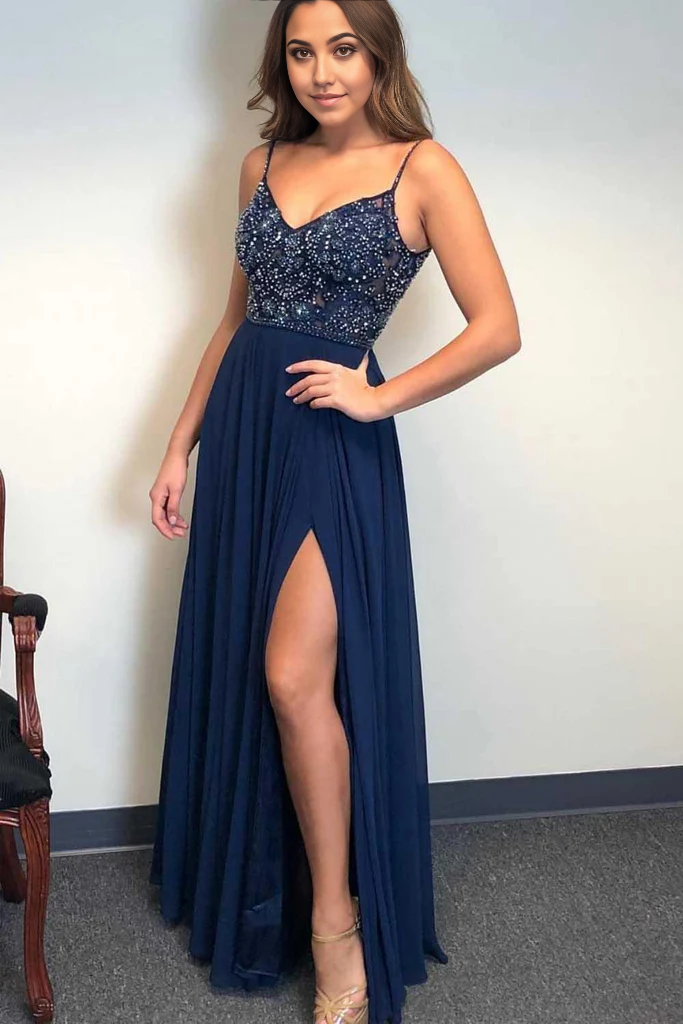 Elegant A-line dark navy long prom dress with spaghetti straps and intricate beading.