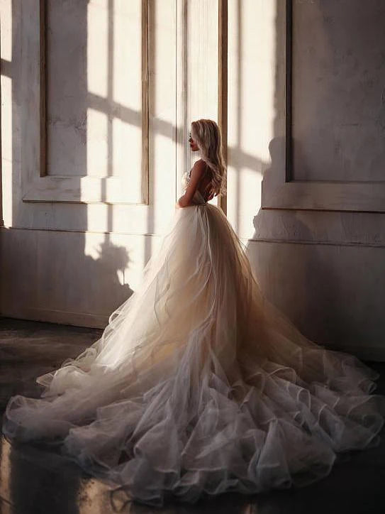 Side view of the floor-length A-line gown with straps.
