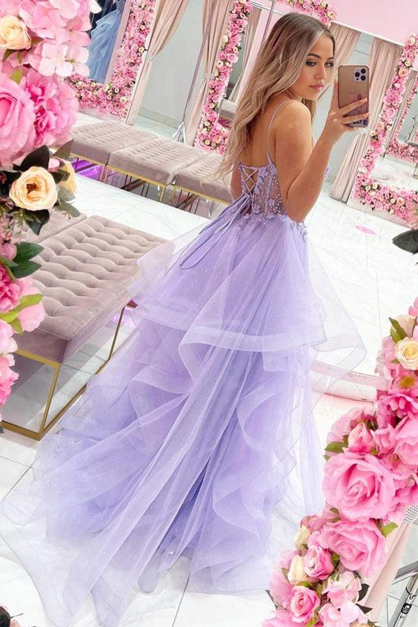 Close-up of beaded lace and floral details on purple prom dress.