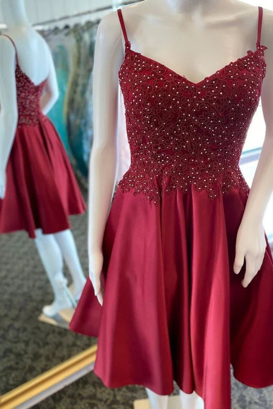 A-line V-neck short homecoming dress with intricate beading and lace details.