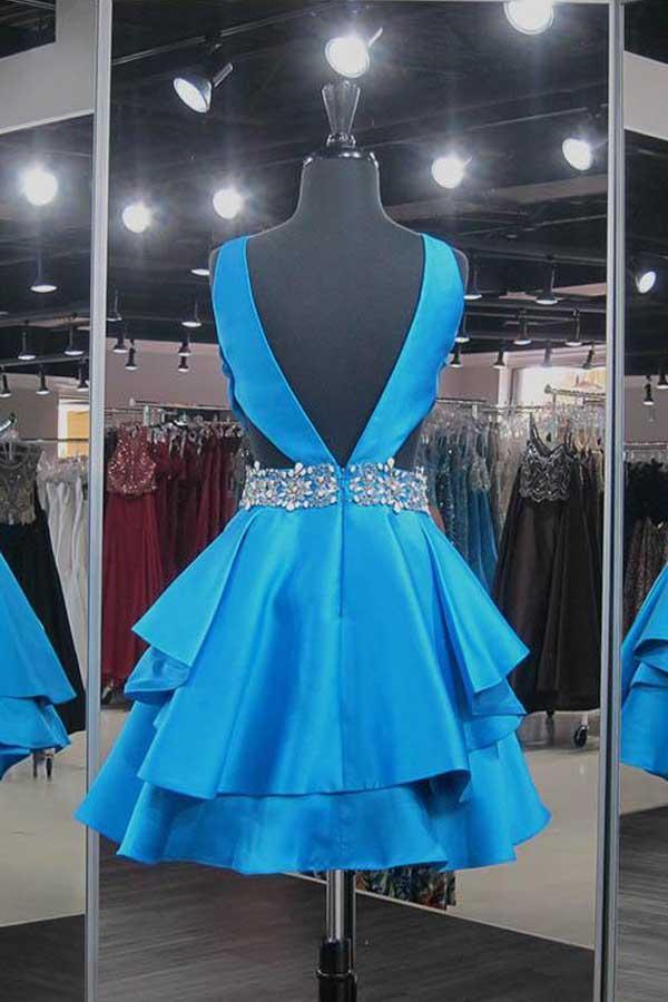 Close-up of the beaded V-neckline on a blue satin homecoming dress.