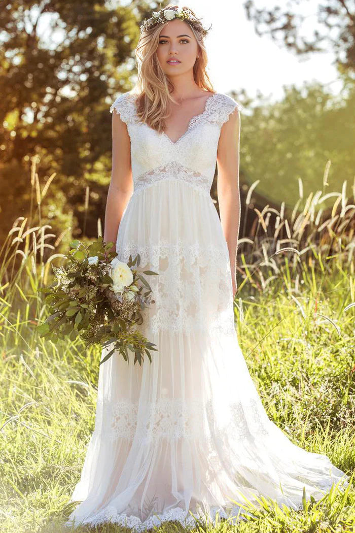 Elegant A-line V-neck wedding dress with appliqued lace and tulle skirt.