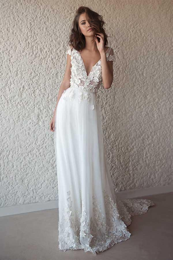 Elegant ivory A-line wedding dress with cap sleeves and sheer details.