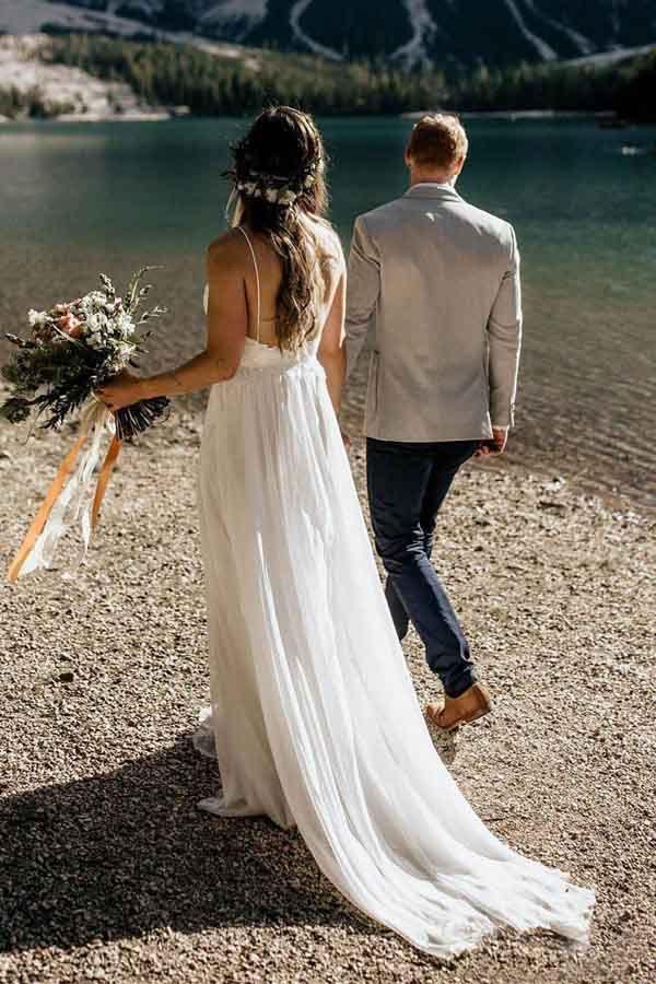 Close-up of the intricate lace bodice and spaghetti straps on the chiffon wedding dress.