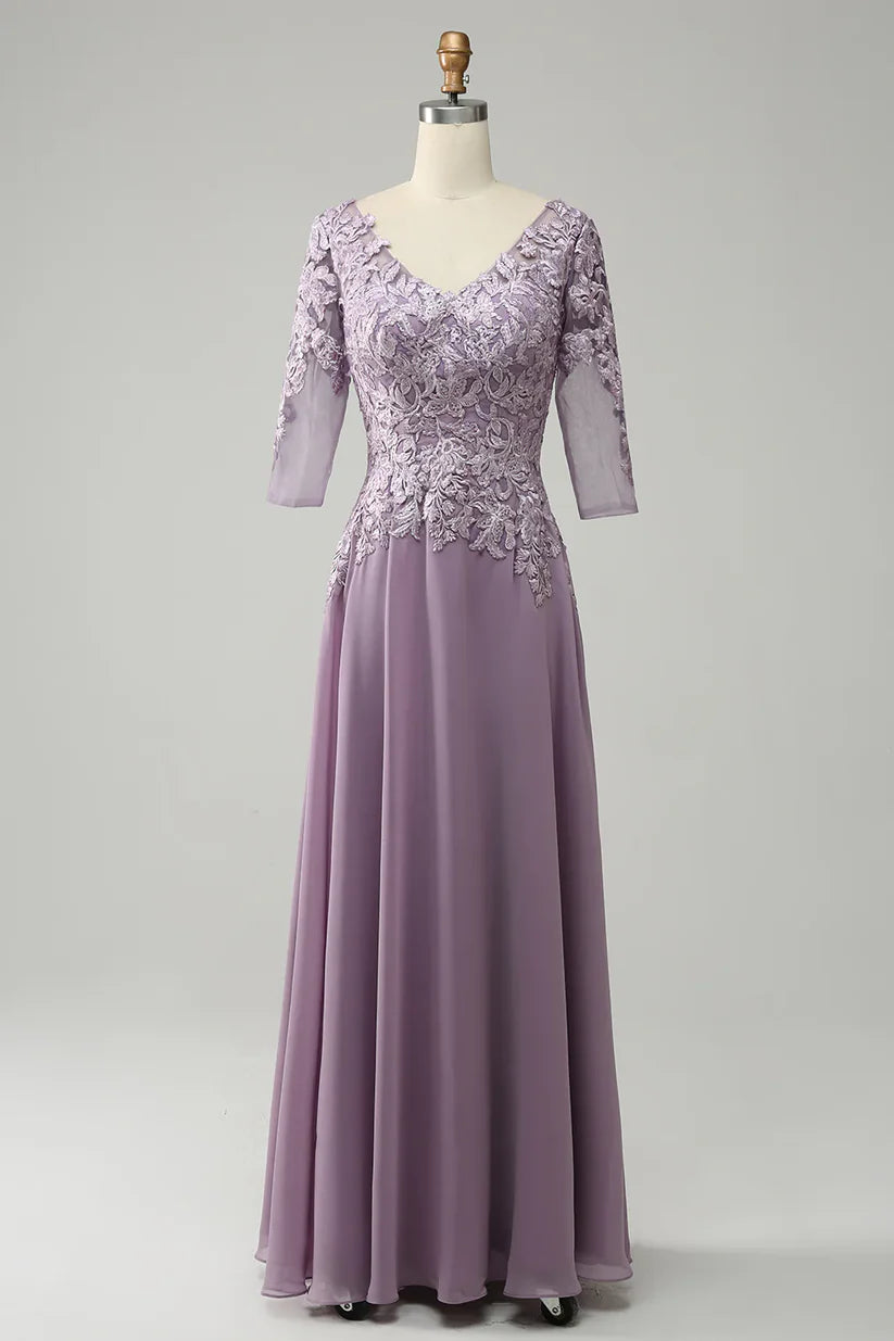 Woman wearing an elegant A-line chiffon Mother of the Bride dress with lace details and a V-neck.