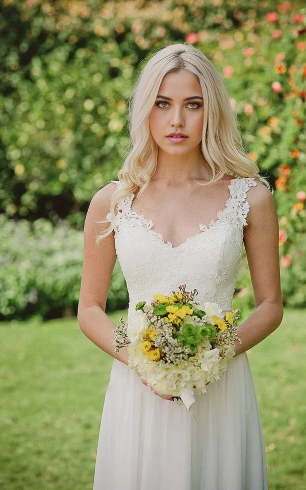 Close-up of delicate lace and sparkling beading on the wedding dress.