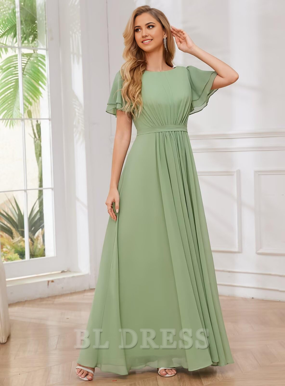 Back view of a woman in a long A-line V-neck formal dress with chiffon sleeves.
