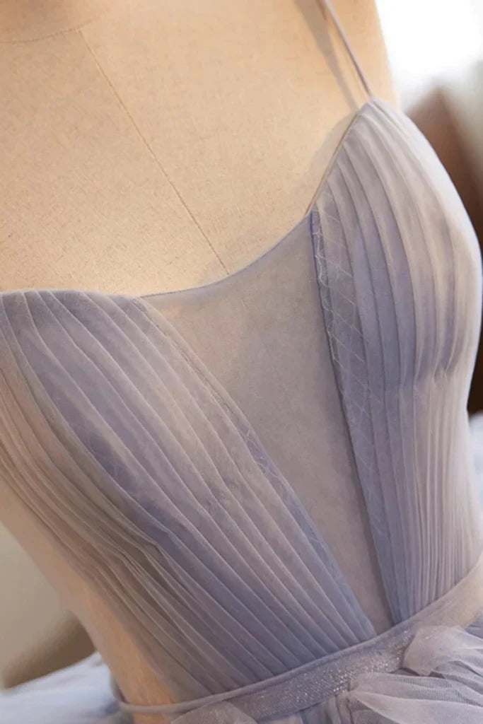 Side view of high-low tulle prom dress showcasing the flowing train.