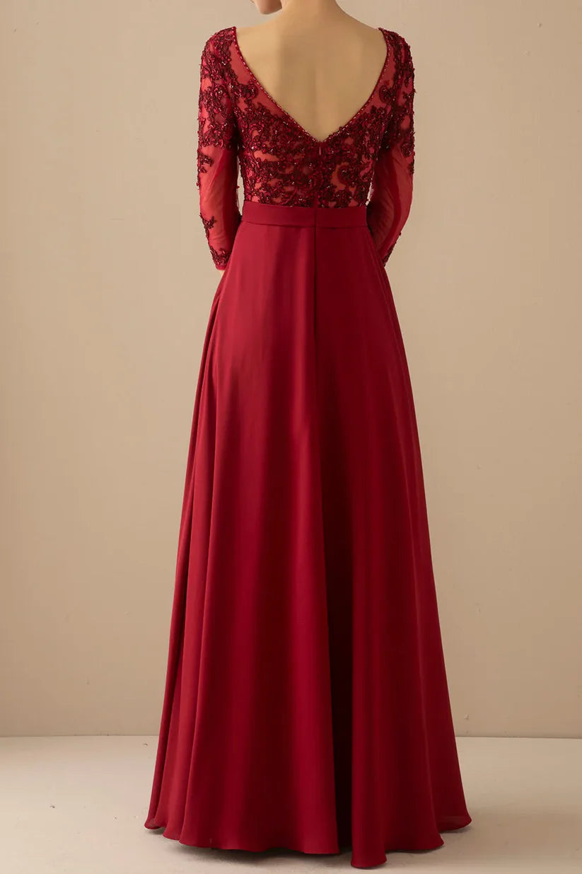 Formal A-line gown featuring illusion sleeves and V-neckline.