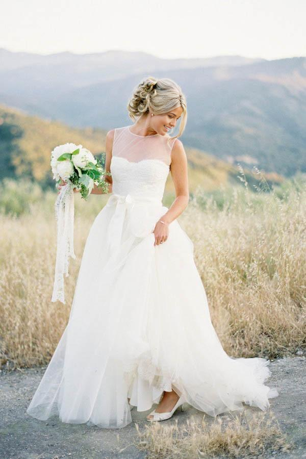 Front view of an A-line vintage ivory wedding dress with V-neck and illusion tulle.