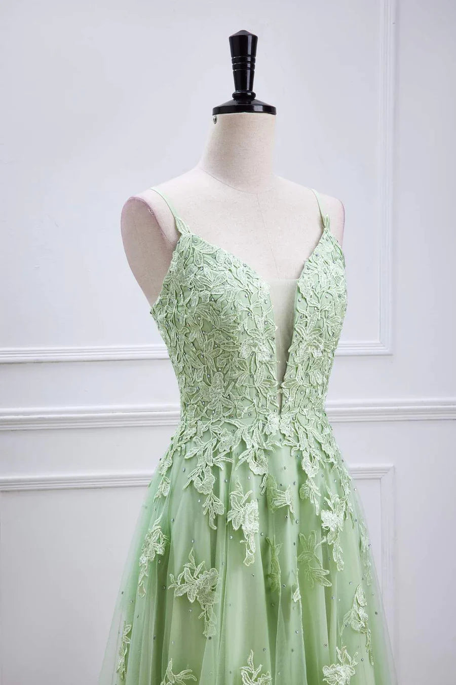 Side view of sage green A-line prom dress with flowing skirt.