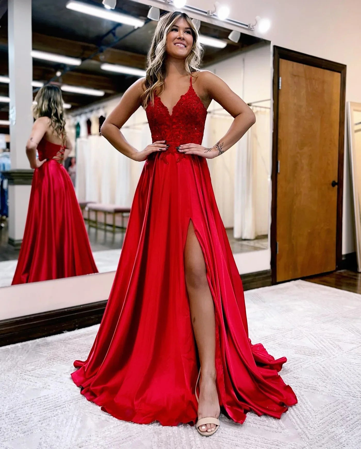 Red A-line prom dress with lace applique and spaghetti straps.