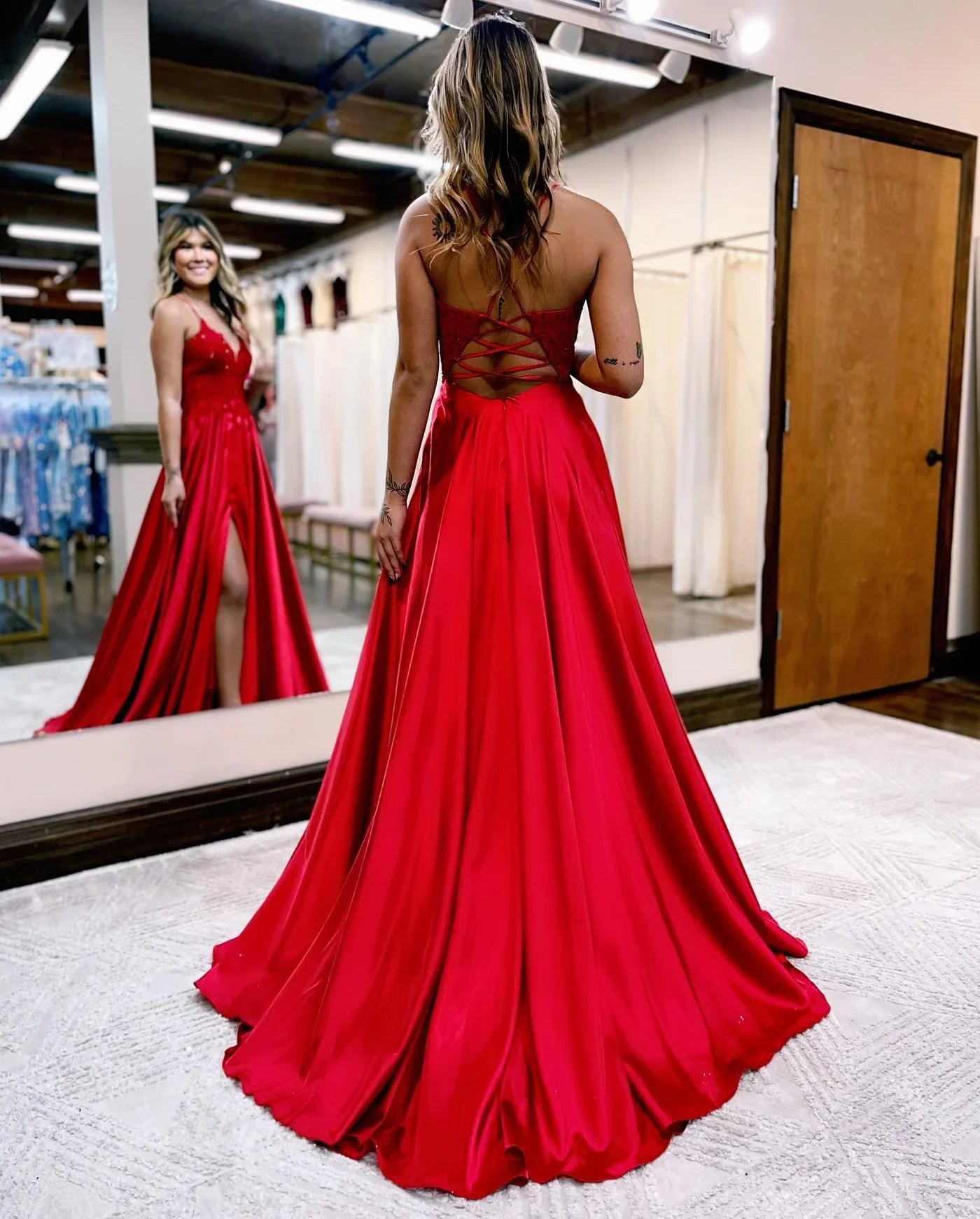 Back view of red A-line formal dress with corset lacing.