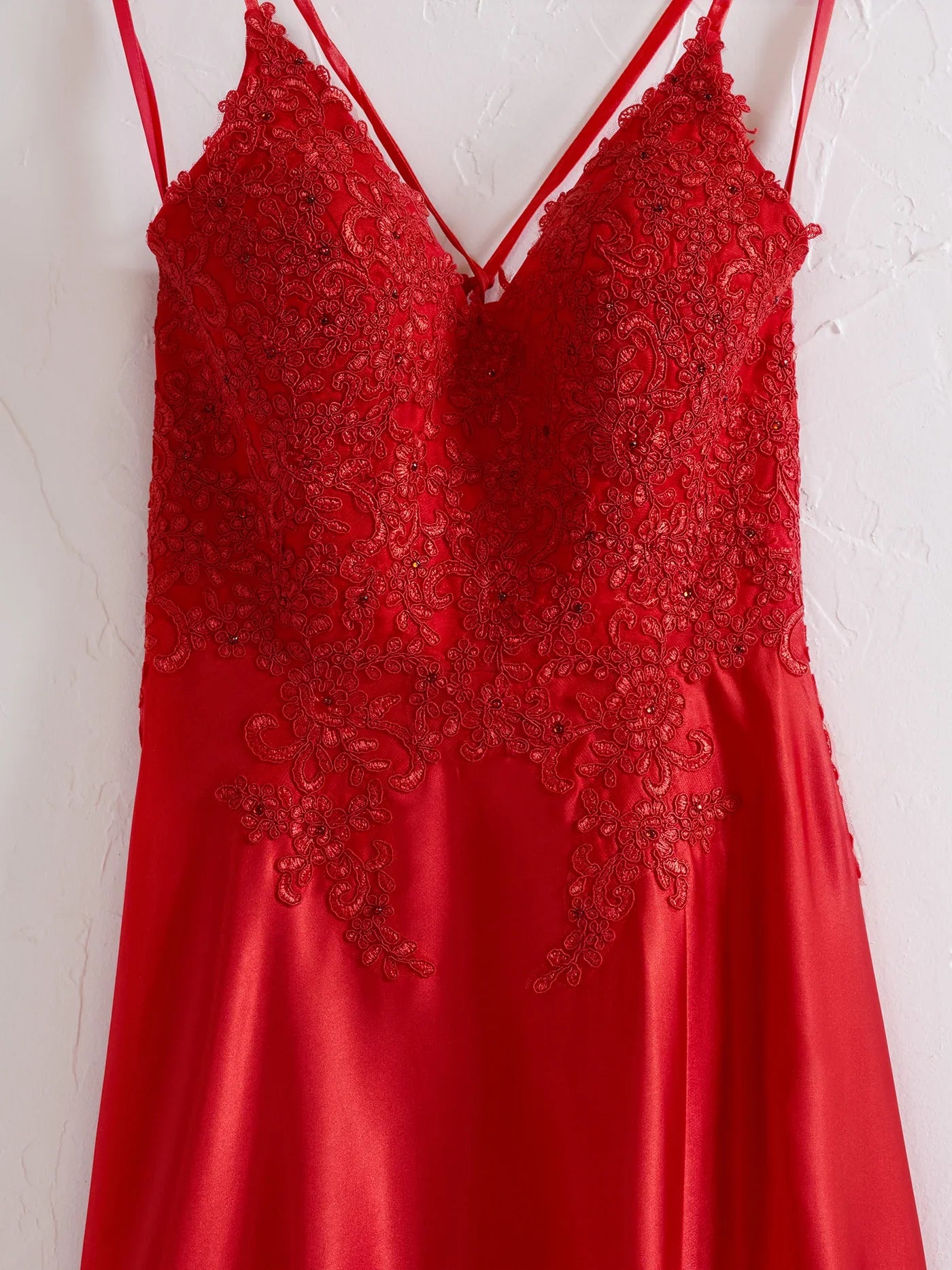 Side view of red A-line gown with delicate lace details.