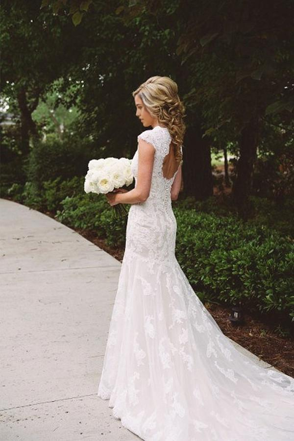 Elegant A-line wedding dress with lace appliques and V-neckline.