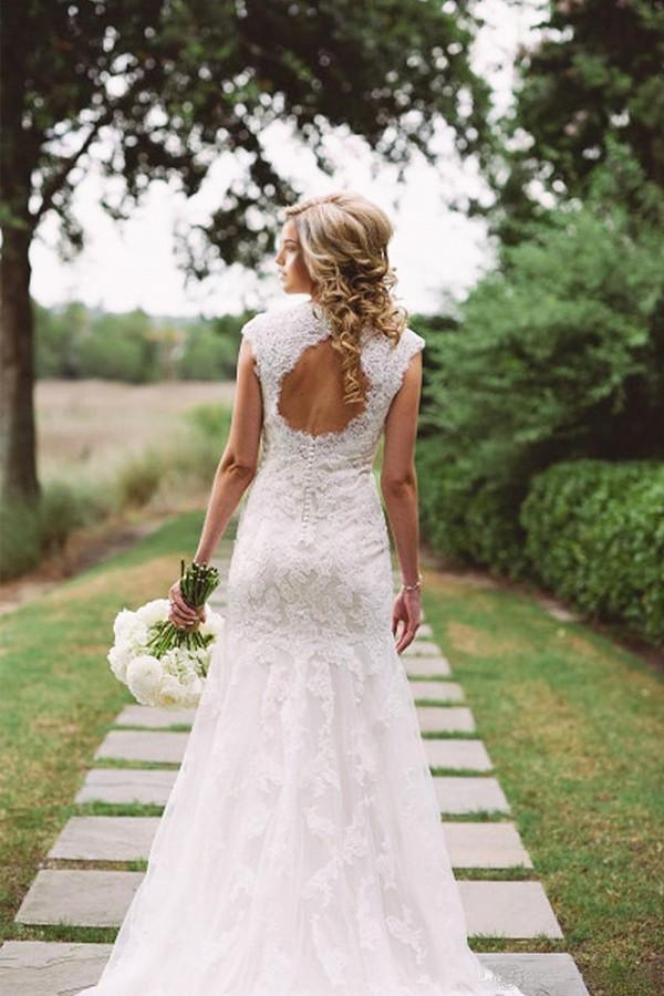 Back view of A-line wedding dress showing button details and flowing skirt.