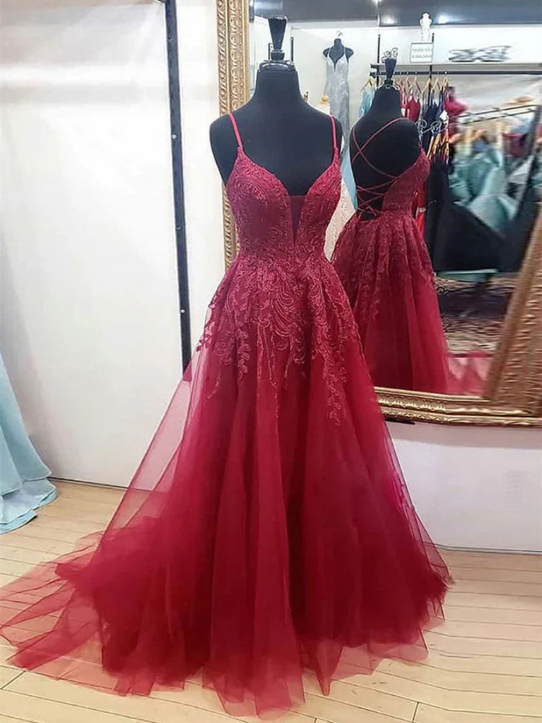 Woman wearing an elegant A-line V-neck lace backless long prom dress.