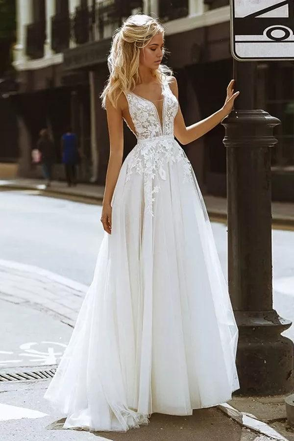 Elegant A-line V-neck lace wedding dress with a flowing skirt.