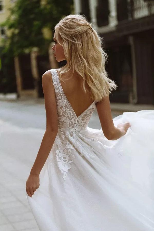 Close-up of the lace detail on an elegant beach wedding dress.