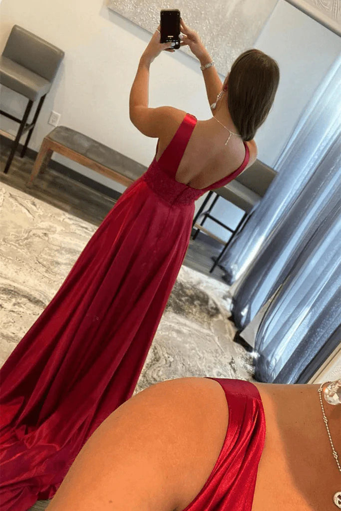 Burgundy V-neck lace evening gown with intricate detailing.