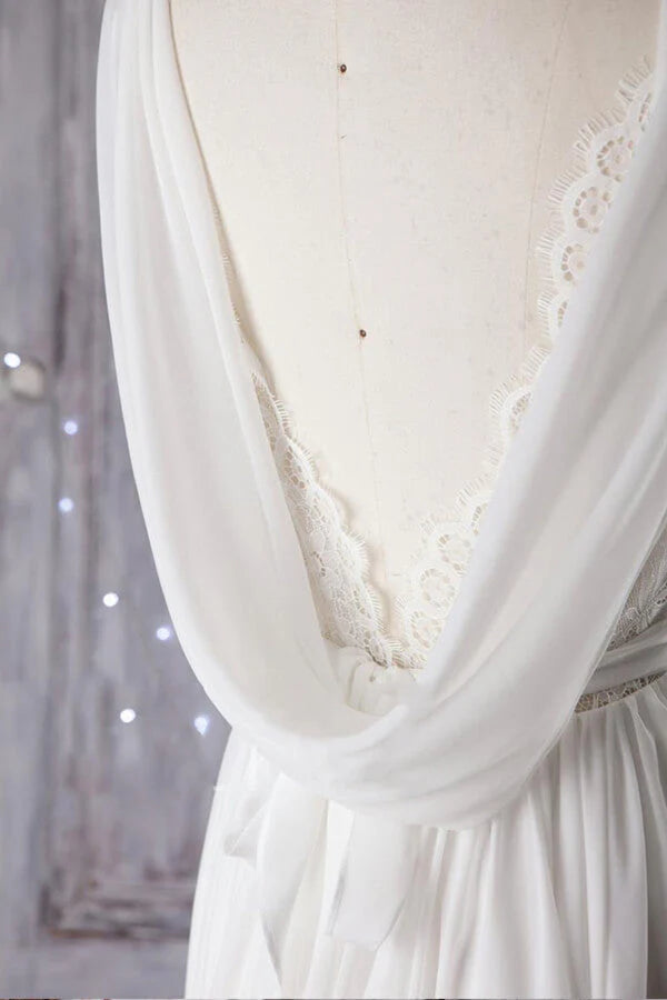 Close-up of the delicate lace detailing on the V-neck of the wedding dress.
