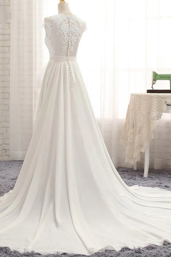 Close-up of delicate lace appliques and V-neckline on the wedding gown.