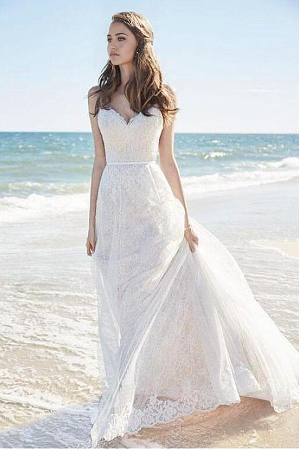 Elegant A-line lace wedding dress with spaghetti straps and V-neckline.