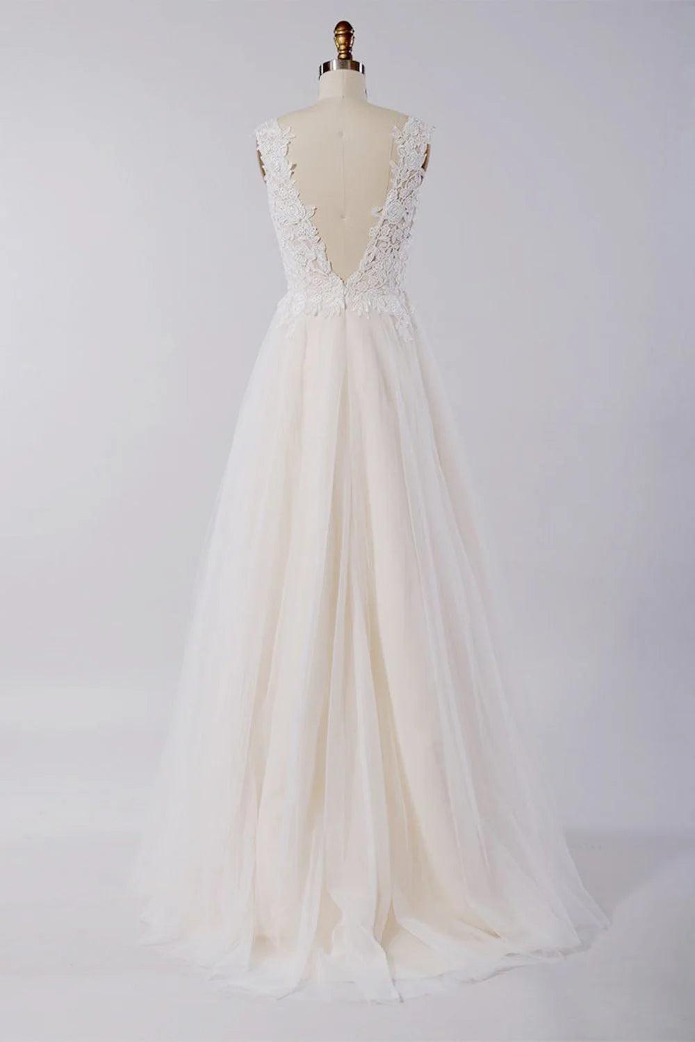 Close-up of the V-neckline and delicate lace appliques on the wedding dress bodice.