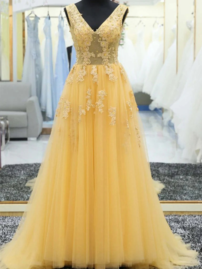Model wearing an elegant A-line V-neck lace and tulle long prom ball gown.