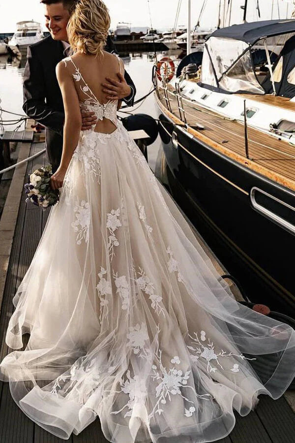 Elegant A-line wedding dress with chapel train, lace appliques, and V-neck.