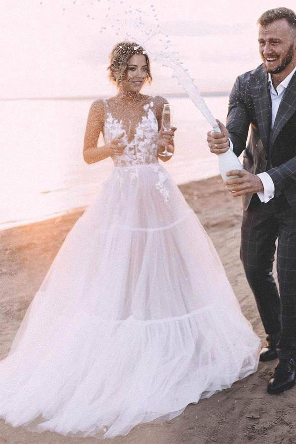 Elegant A-line V-neck lace wedding dress with layered tulle skirt.