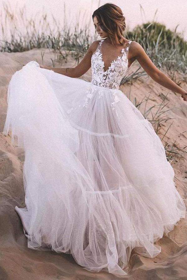 Bride wearing A-line tulle wedding dress in an outdoor setting.