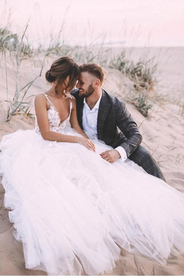 Side view of A-line V-neck wedding gown with flowing skirt.