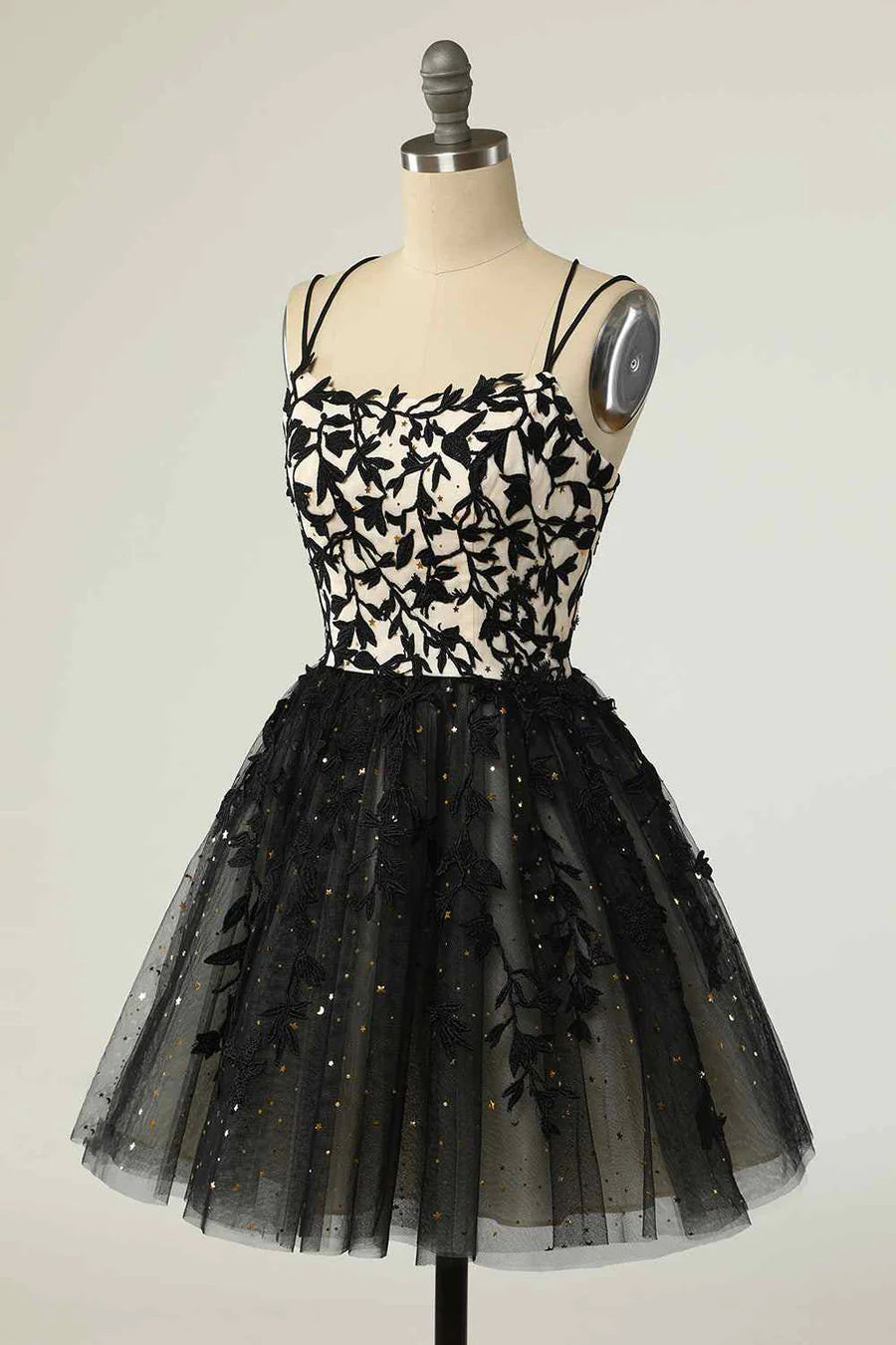 Back view of the A-line mini homecoming dress, highlighting the lace-up closure and intricate applique.