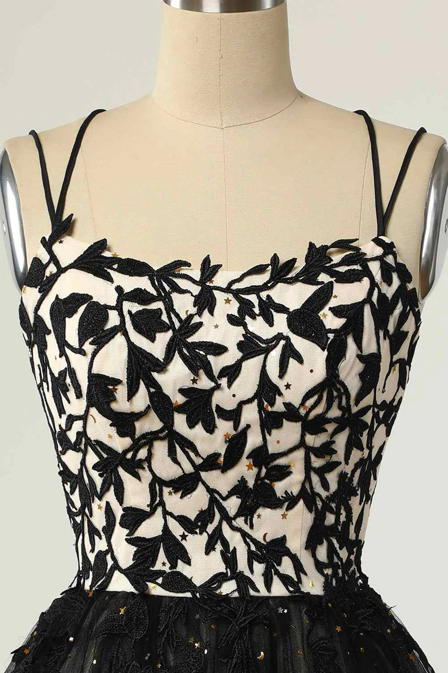 Close-up of the delicate applique and lace-up detail on the mini homecoming dress.